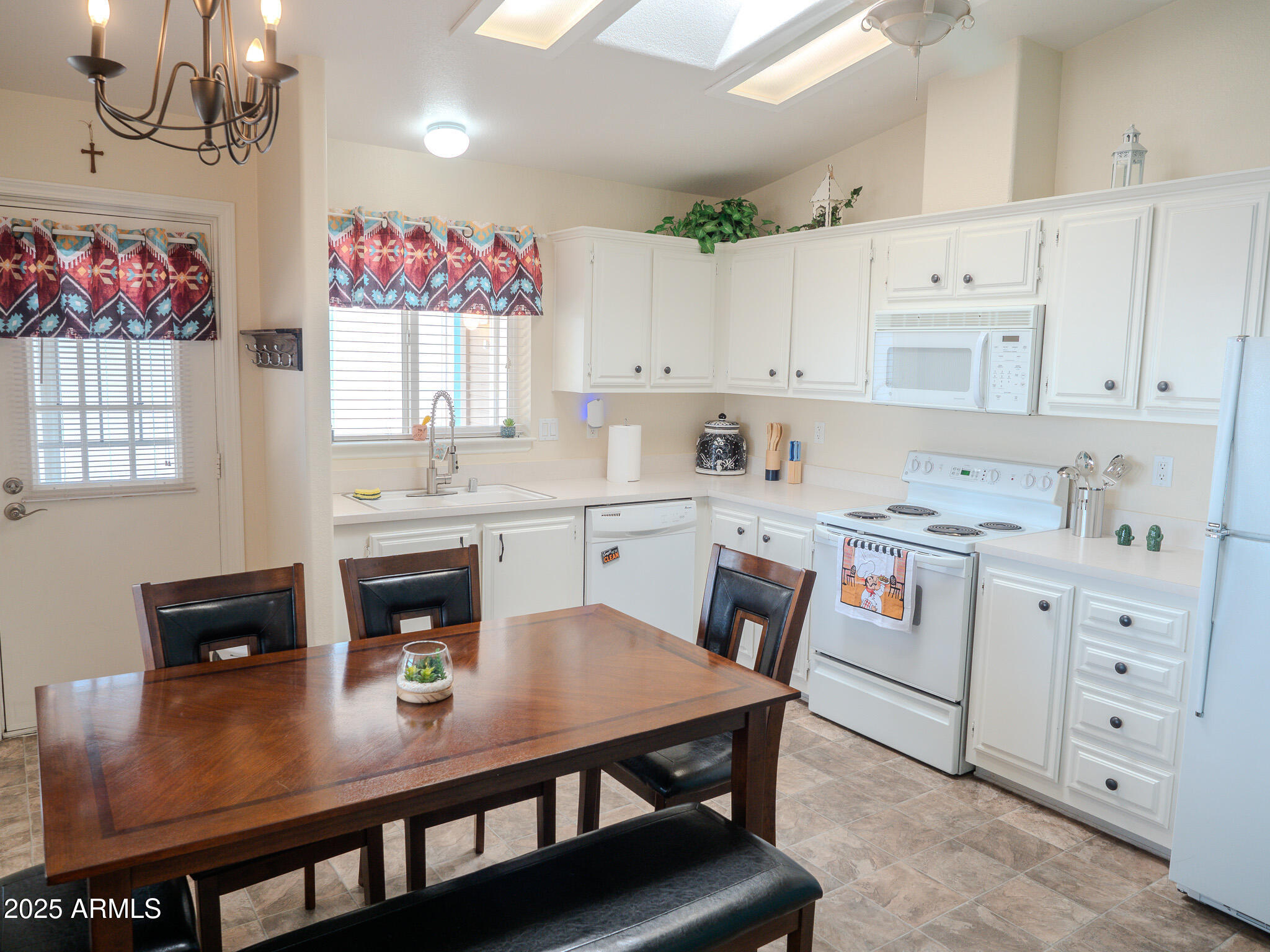 8865 East Baseline Road, Unit 1207 Mesa, AZ 85209 - Photo 14 of 40 a kitchen with cabinets appliances and a dining table
