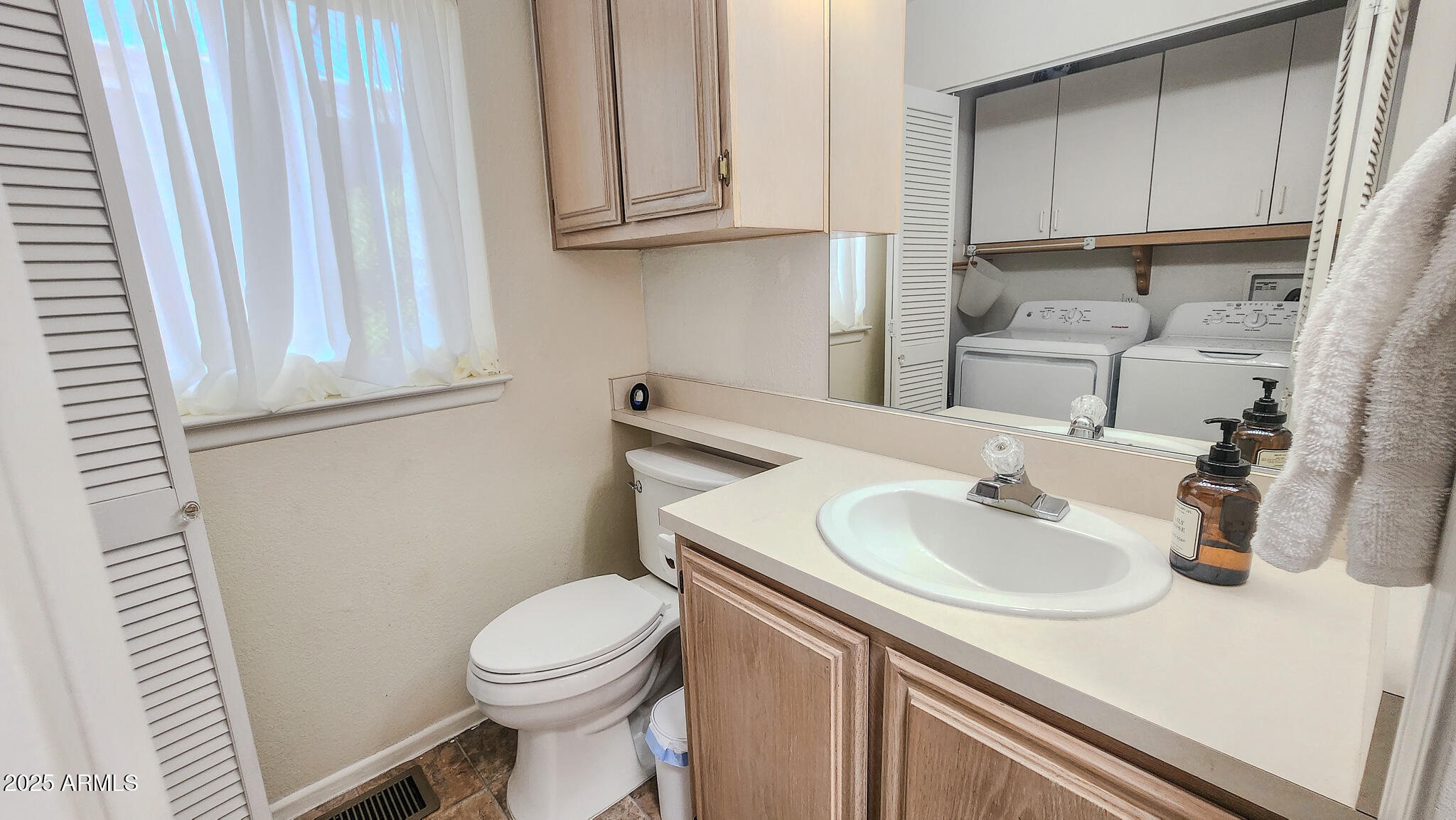 8865 East Baseline Road, Unit 1207 Mesa, AZ 85209 - Photo 25 of 40 a bathroom with a sink a toilet and vanity