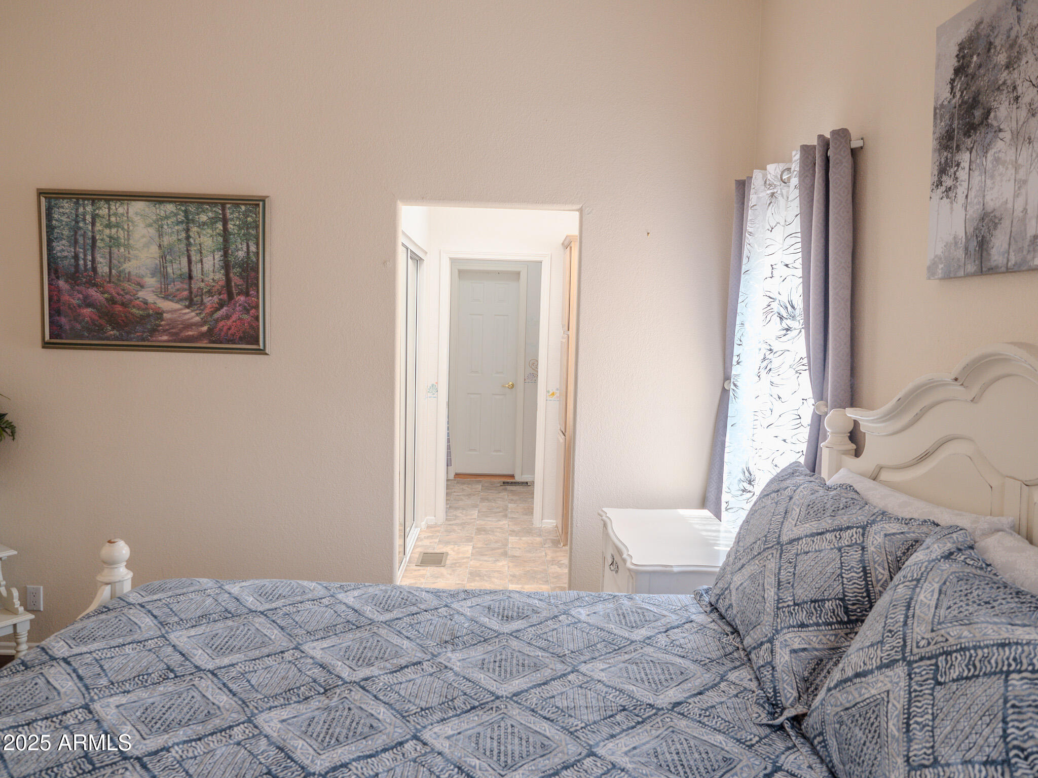 8865 East Baseline Road, Unit 1207 Mesa, AZ 85209 - Photo 31 of 40 a bedroom with a bed and a painting on the wall