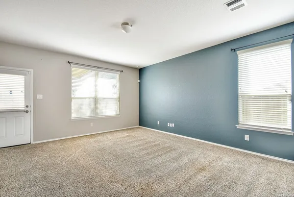 a view of an empty room with a window