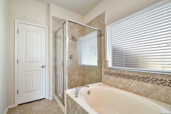 a bathroom with a bathtub and shower