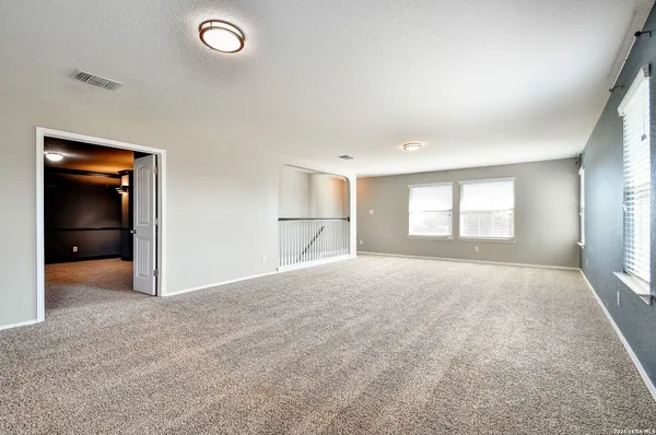 a view of empty room with a window and fireplace