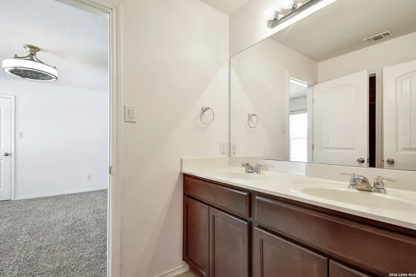 a bathroom with a double vanity sink and a mirror