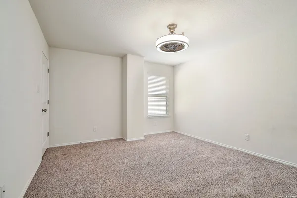 a view of an empty room and a window