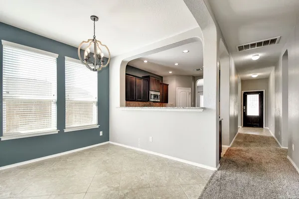 a view of a hallway with a chandelier and chandelier