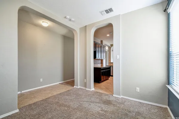 an empty room with kitchen and sink