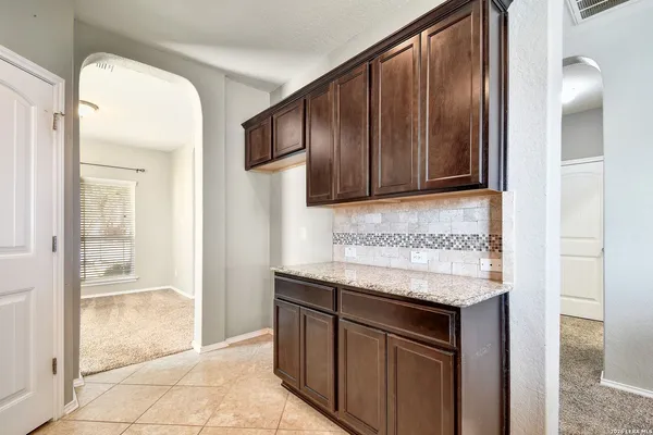 a kitchen with stainless steel appliances granite countertop wooden cabinets a sink and dishwasher