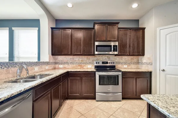 a kitchen with a sink stove and microwave