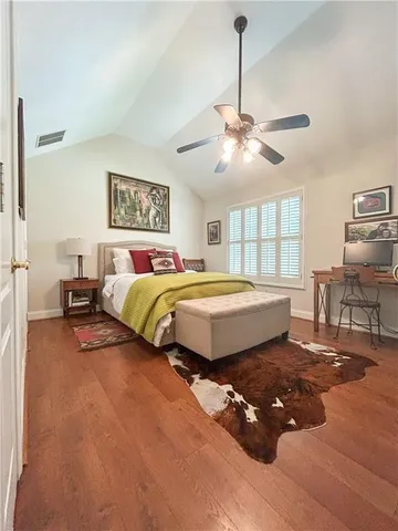 a bedroom with a bed window and a table