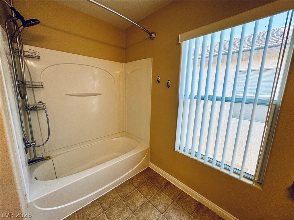 8617 Palomino Ranch Street Las Vegas, NV 89131 - Photo 25 of 27 Functional bath with shower-over-tub combination and tiled flooring.