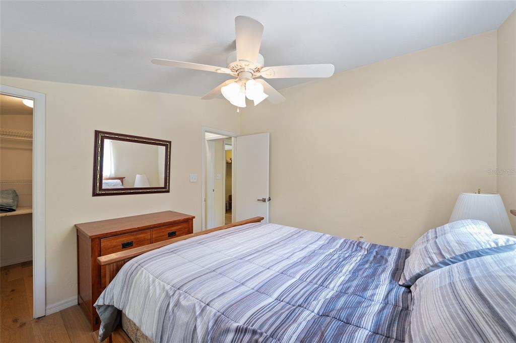 7870 Southwest 25th Place Bell, FL 32619 - Photo 90 of 99 a bedroom with a bed and a chandelier