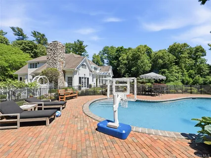 a front view of a house with swimming pool and sitting area