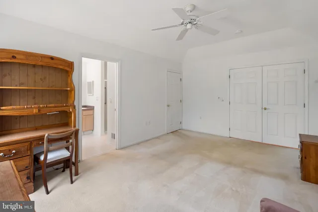 a view of an empty room with a ceiling fan