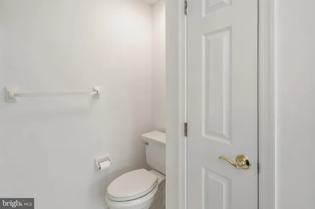 a white toilet sitting next to a shower