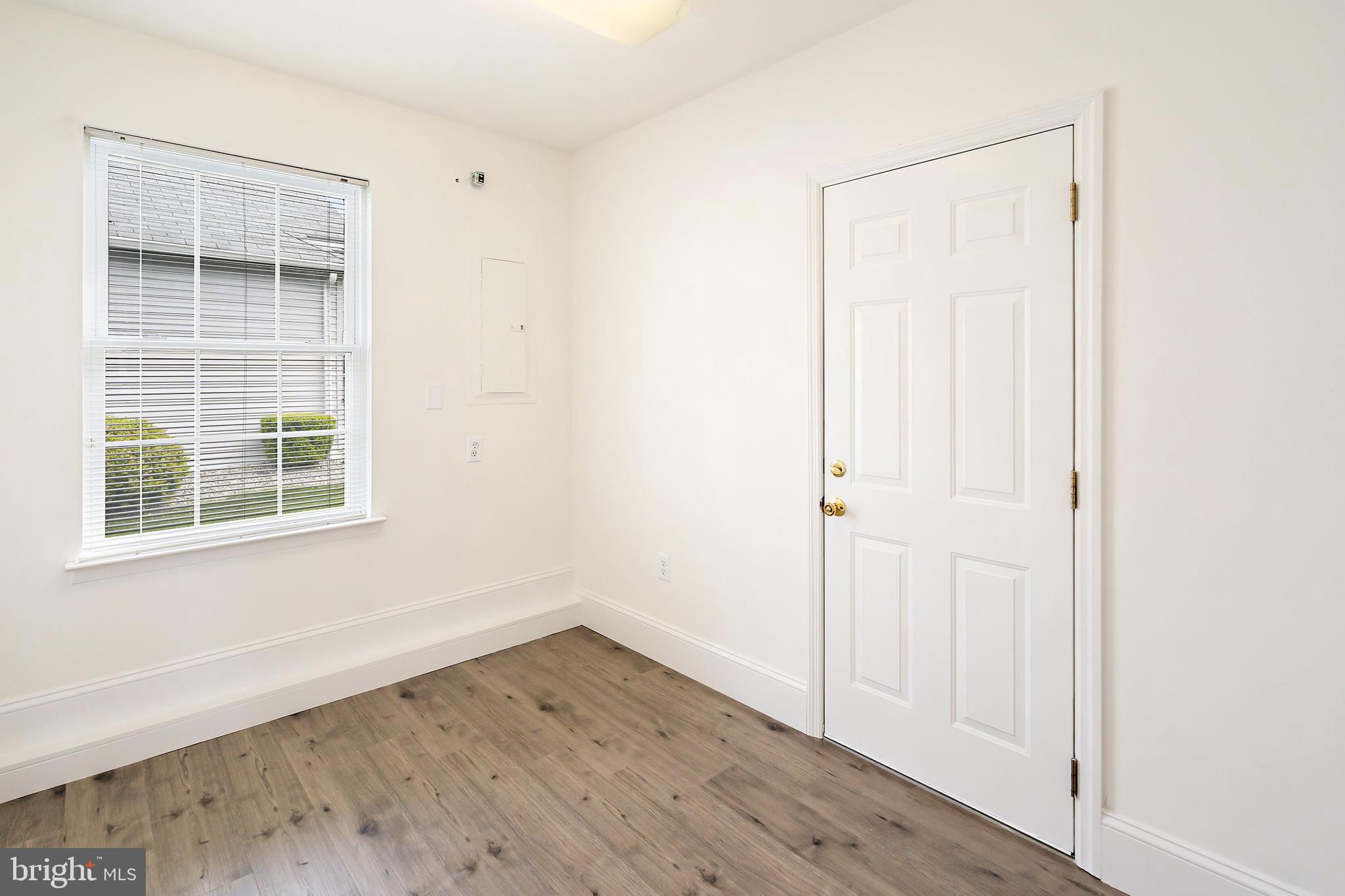 12 Rye Court Jackson, NJ 08527 - Photo 23 of 32 an empty room with wooden floor and windows