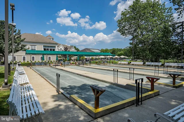 a view of a swimming pool with seating space and deck