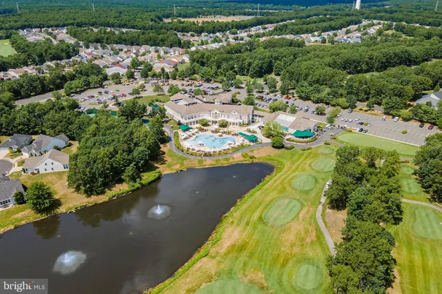 an aerial view of a house with a yard and lake view