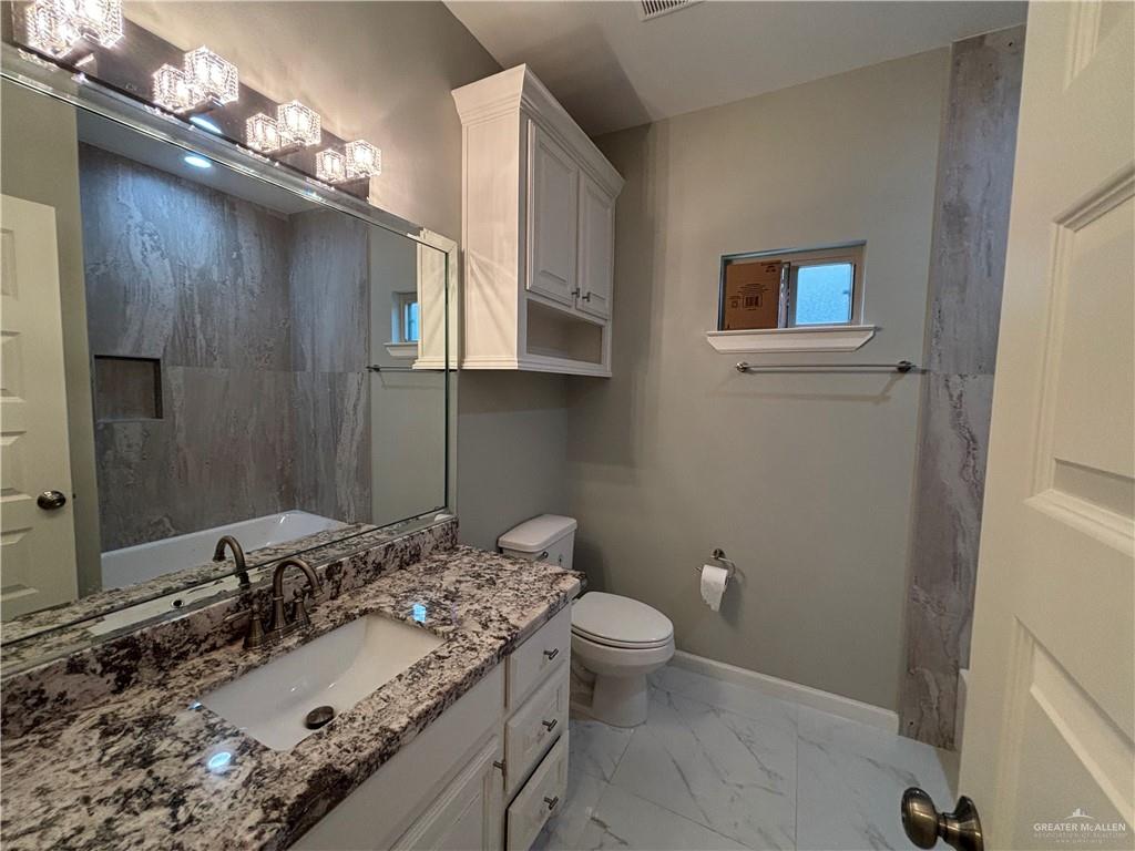 2601 Tulipan Avenue Mission, TX 78574 - Photo 21 of 27 a bathroom with a sink toilet and a mirror