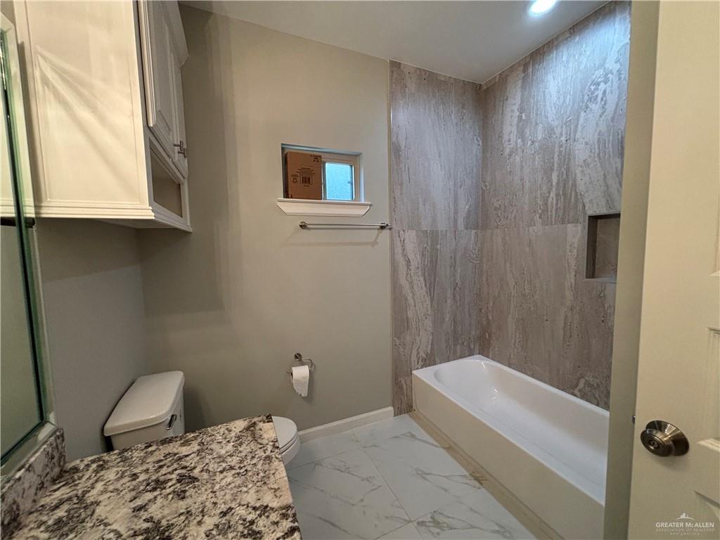 2601 Tulipan Avenue Mission, TX 78574 - Photo 22 of 27 a bathroom with a bathtub and shower