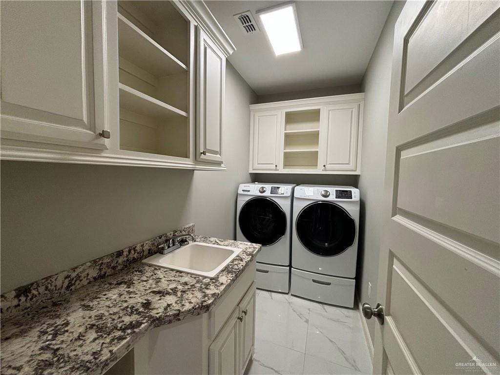 2601 Tulipan Avenue Mission, TX 78574 - Photo 27 of 27 a utility room with dryer and washer