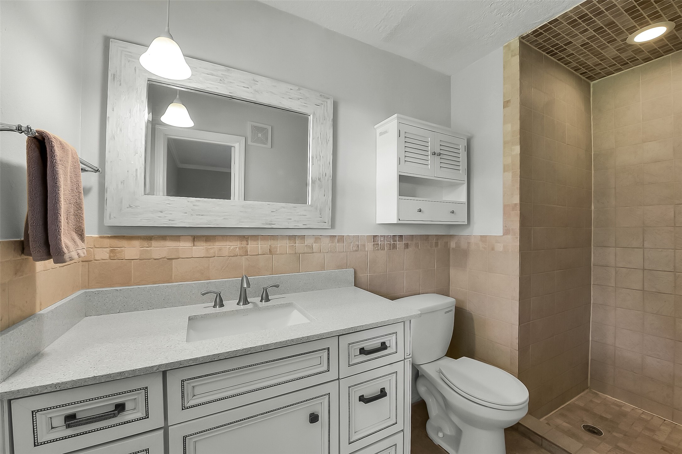 9623 Val Verde Street Houston, TX 77063 - Photo 15 of 26 Primary bedroom en suite bath features a walk-in shower, vanity w/sink & updated lighting.