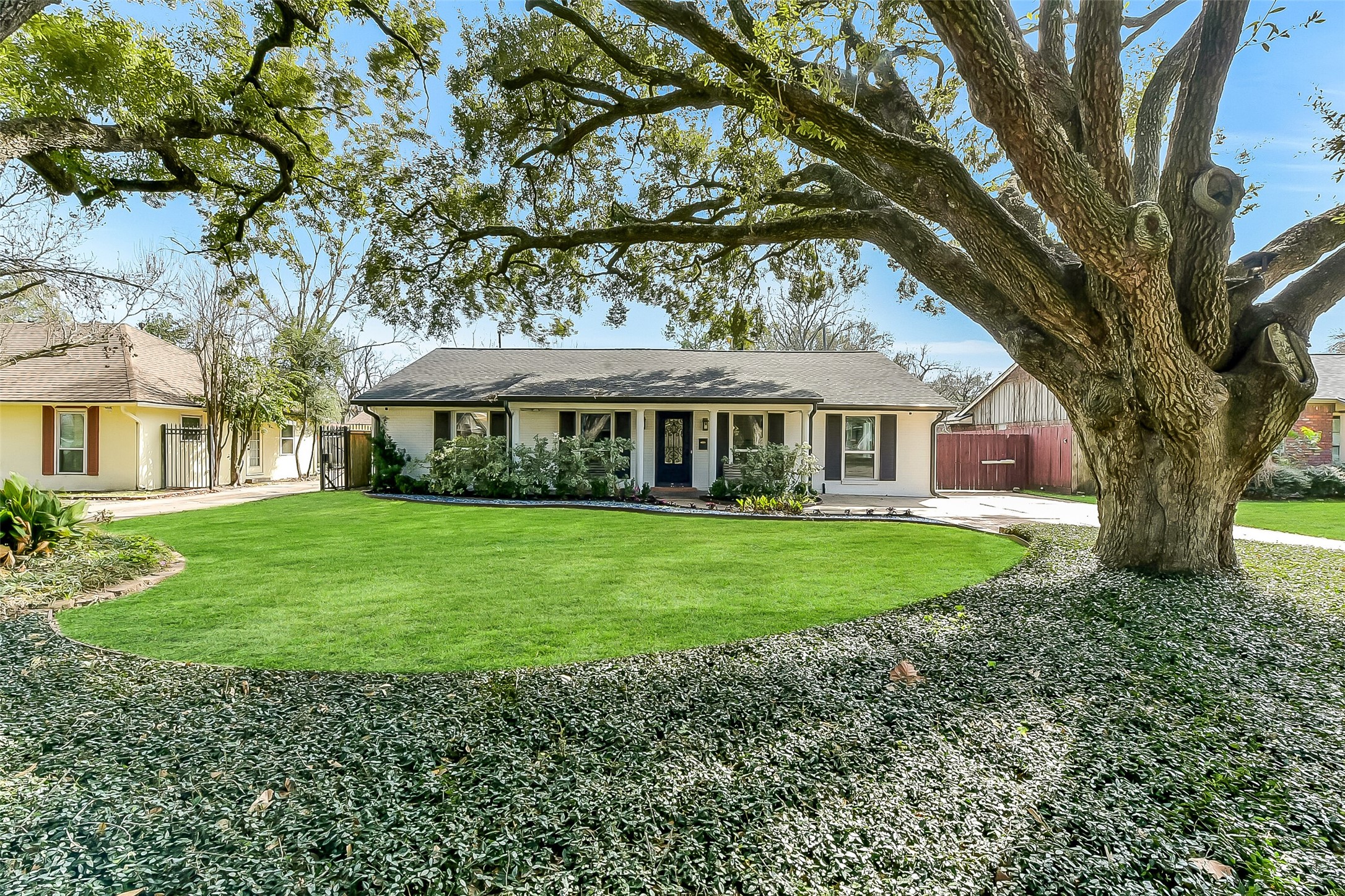 9623 Val Verde Street Houston, TX 77063 - Photo 2 of 26 Inviting curb appeal with majestic mature trees. Driveway offers ample parking & convenient access through electronic driveway gate to your 2 car detached garage. Exterior refresh with gutters ('22), landscaping & lighting ('21).