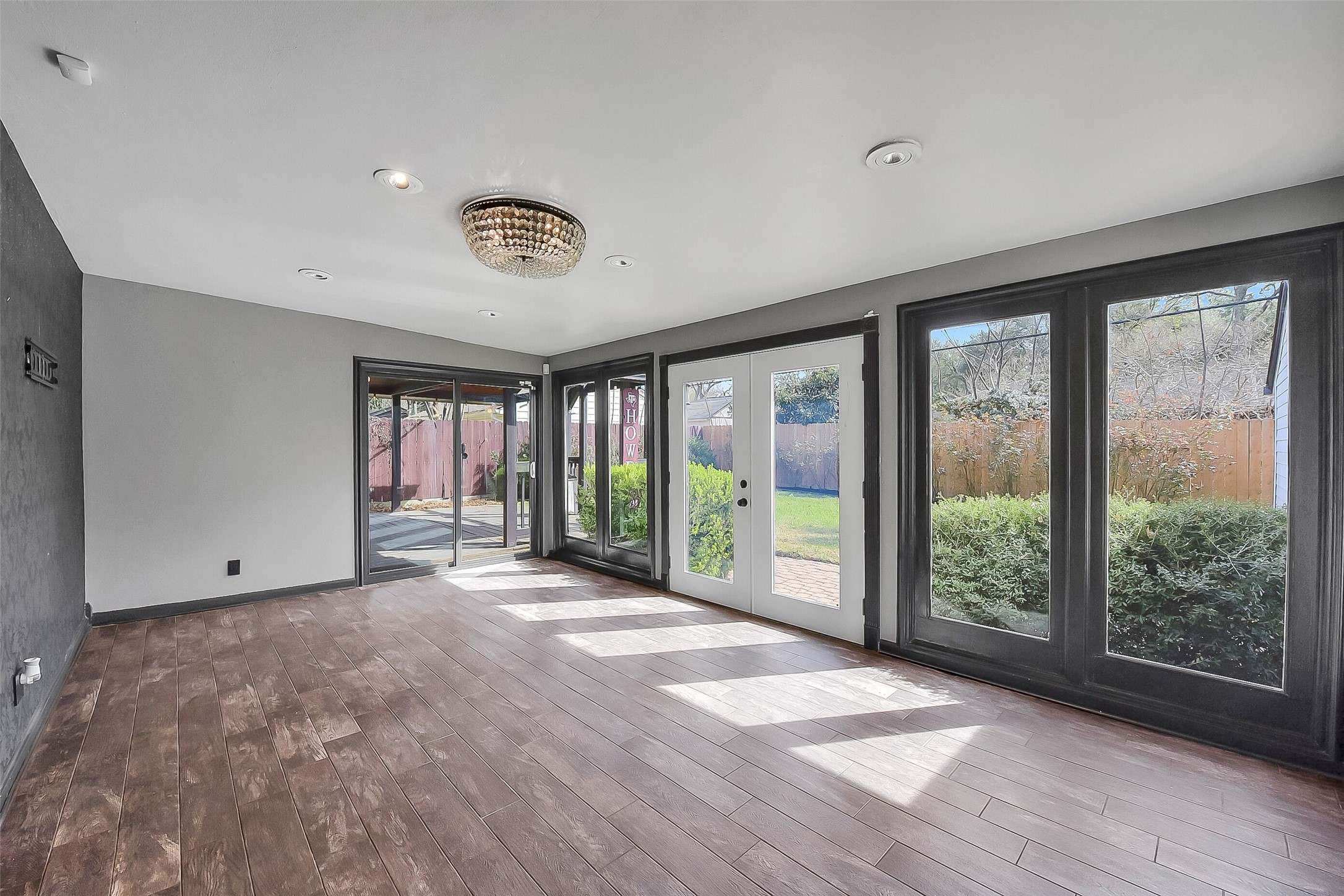 9623 Val Verde Street Houston, TX 77063 - Photo 20 of 26 Alternate view of sunroom - not staged - reveals seamless indoor-outdoor connection w/sliding glass door to deck and additional exterior access to backyard green space. This light-filled bonus room offers so many possibilities for use!