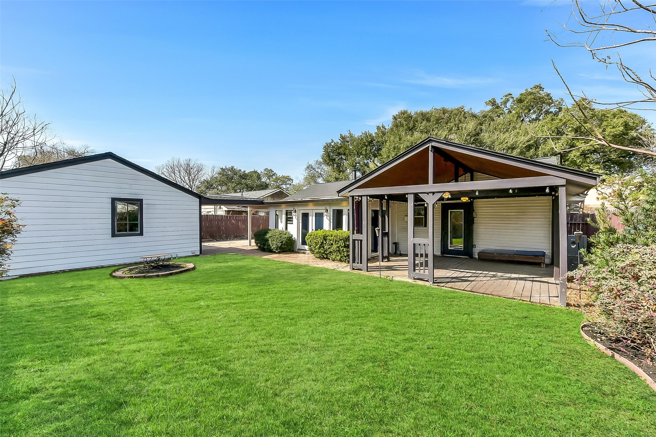 9623 Val Verde Street Houston, TX 77063 - Photo 23 of 26 Generous backyard grass area , offering TONS of space for kids and pets! Notice the detached oversized garage w/storage & utility sink. Covered breezeway conveniently connects the garage to the home.