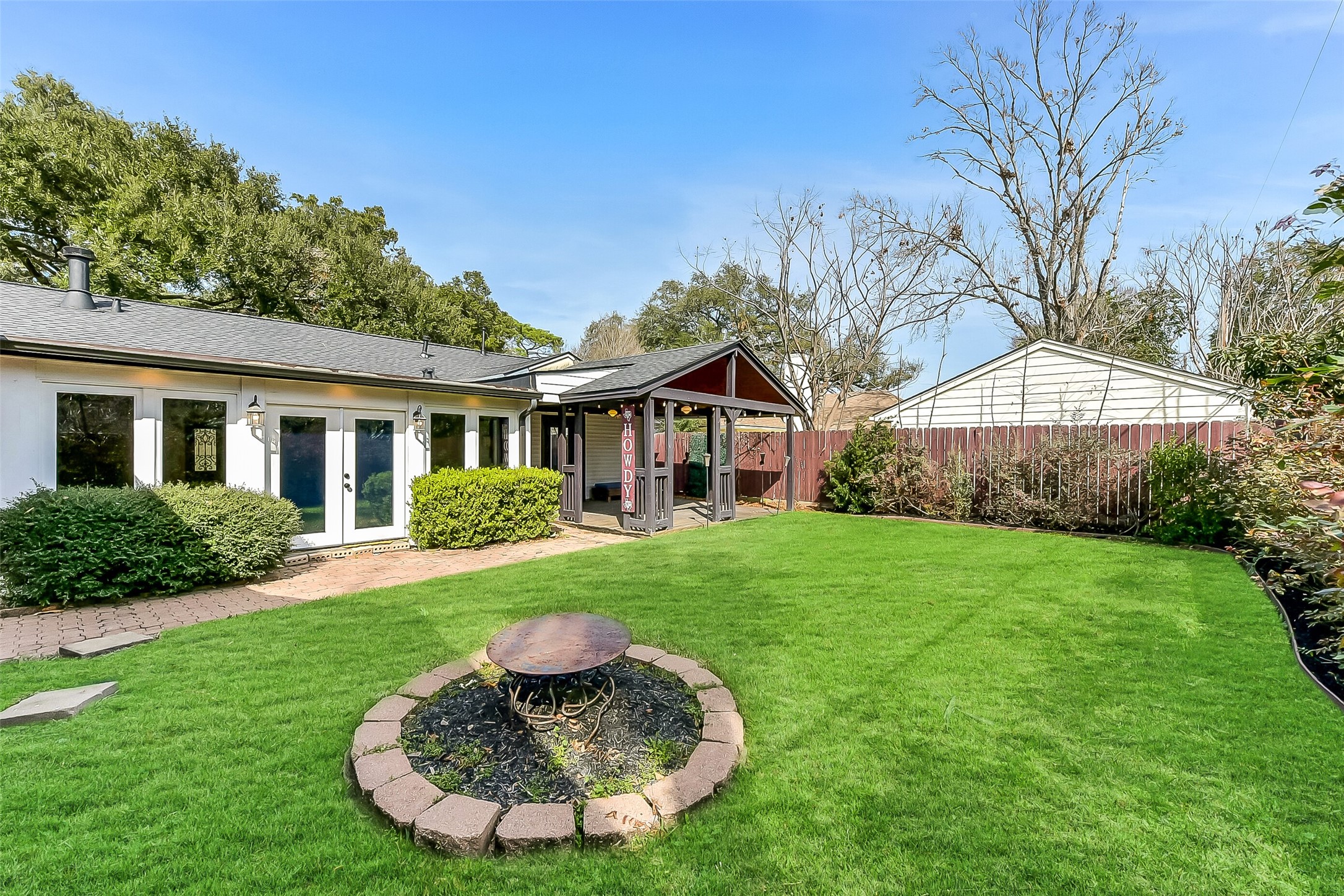 9623 Val Verde Street Houston, TX 77063 - Photo 24 of 26 Another view of the backyard; offering tons of space for outdoor enjoyment. Sprinklers and gutters installed. New rear fence (’25), side fencing (’17) &