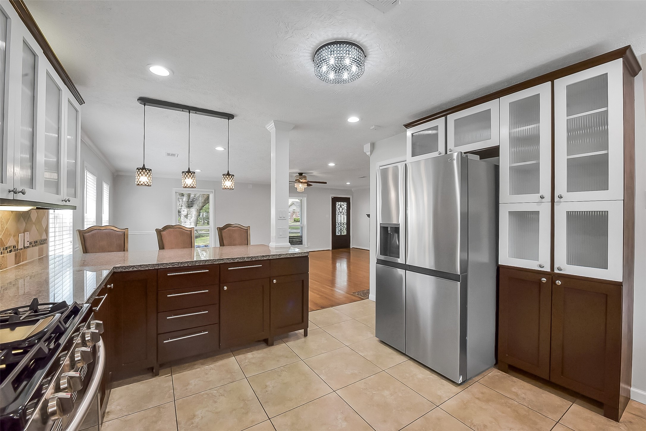 9623 Val Verde Street Houston, TX 77063 - Photo 8 of 26 Additional kitchen view highlighting the custom two-tone cabinetry, generous storage & seamless connection to the living spaces.