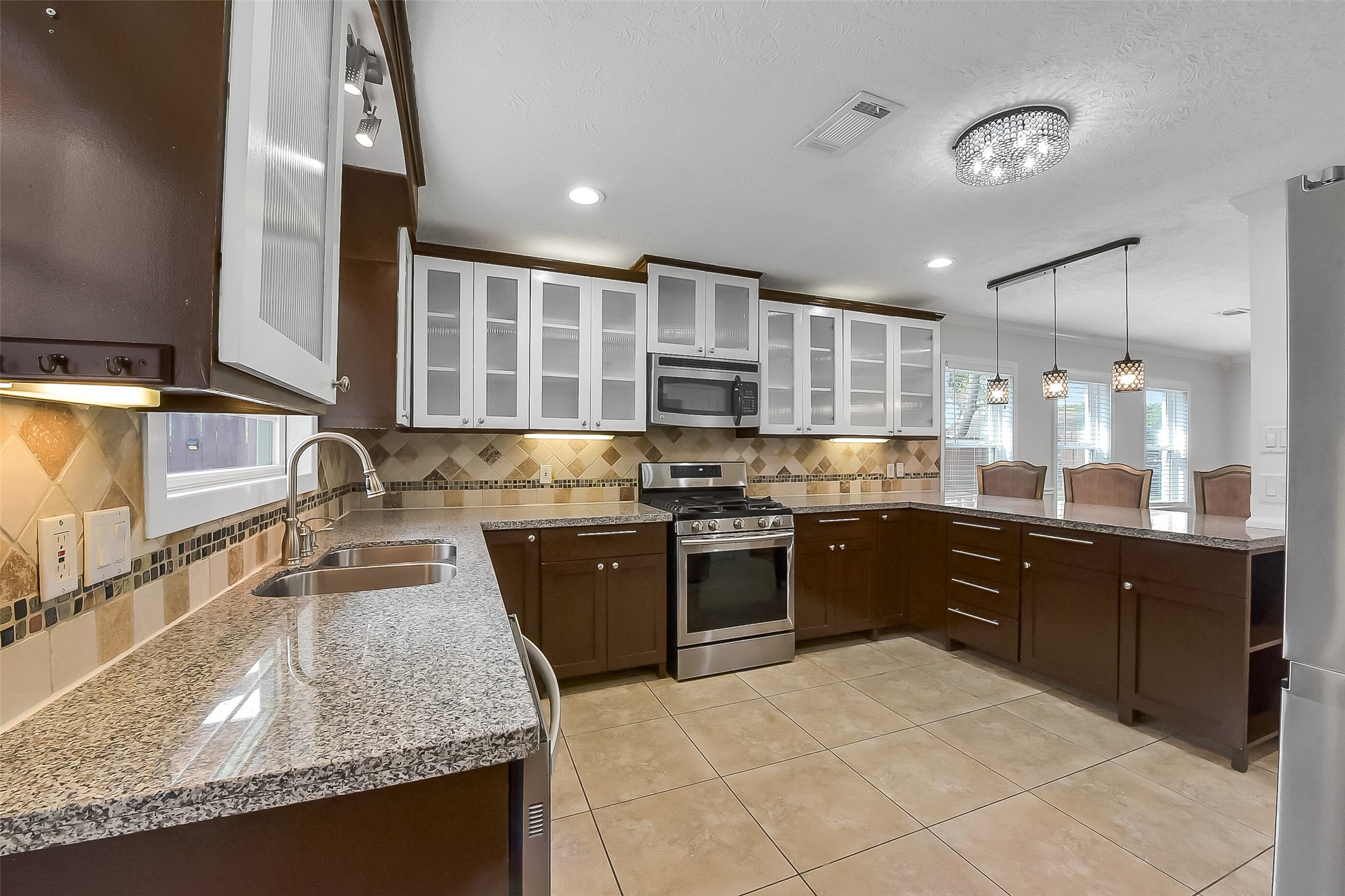 9623 Val Verde Street Houston, TX 77063 - Photo 9 of 26 Kitchen opens comfortably to dining area, enhancing flow for hosting & everyday convenience.