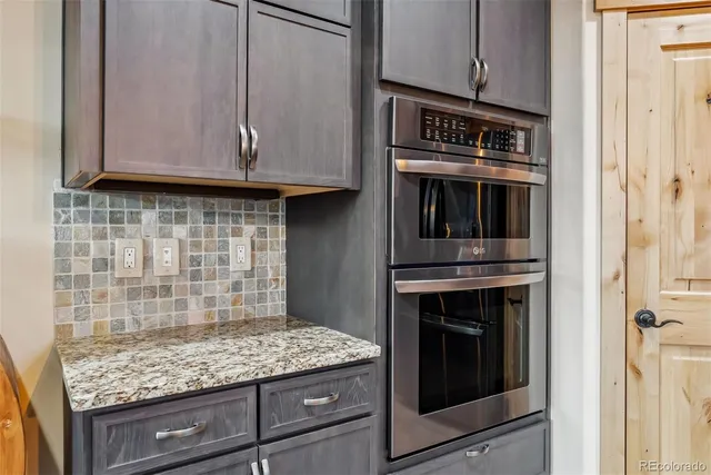 a kitchen with granite countertop cabinets stove and oven