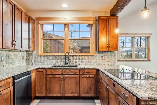 a kitchen with granite countertop a sink and a window