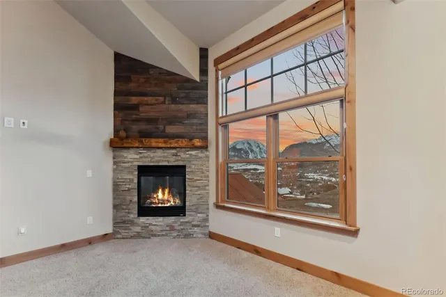a living room with a fireplace and a window