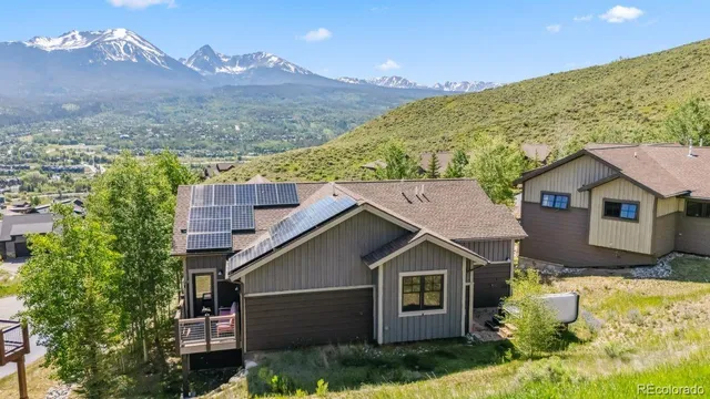 a view of a house with a yard and potted plants