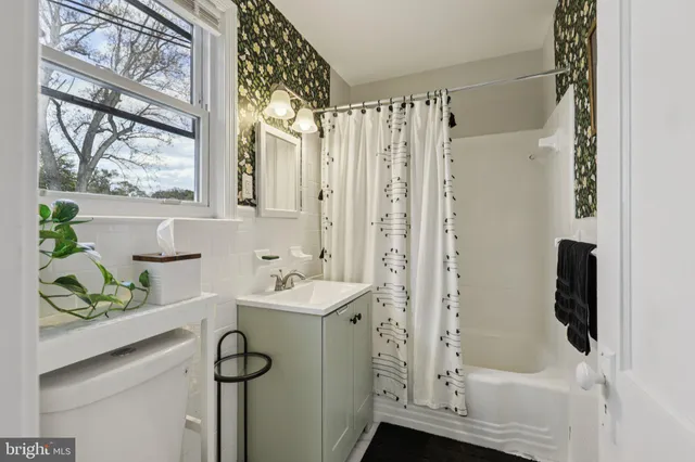 a bathroom with a sink a toilet and a shower