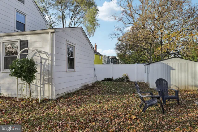 a backyard of a house with table and chairs
