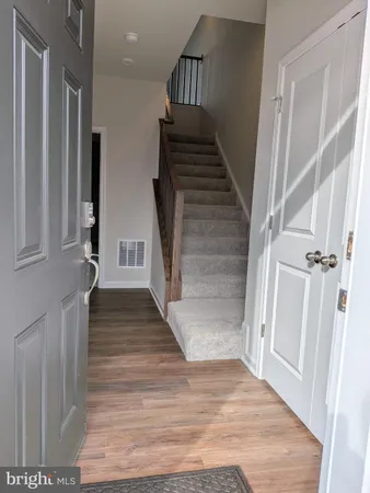 a view of entryway and hall with wooden floor
