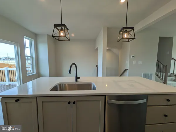 a kitchen with a table and chandelier