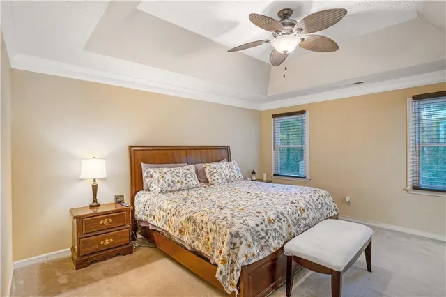 a bedroom with a bed chandelier and a window
