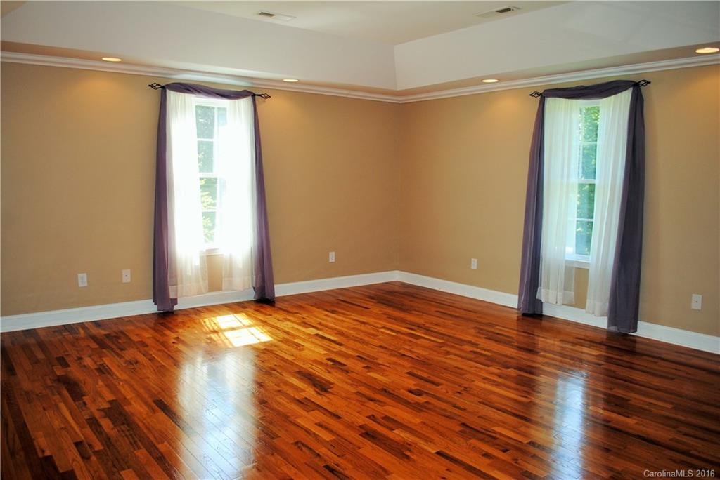 975 Jackson Road Salisbury, NC 28146 - Photo 12 of 24 a view of an empty room with wooden floor and a window