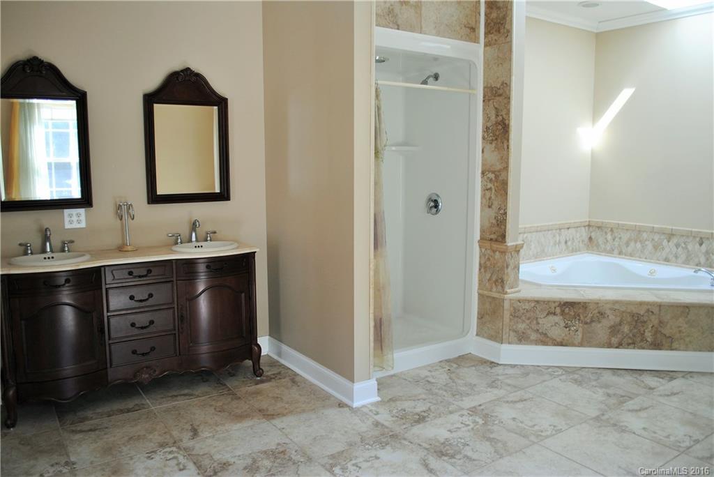 975 Jackson Road Salisbury, NC 28146 - Photo 13 of 24 a bathroom with a double vanity sink mirror and bathtub