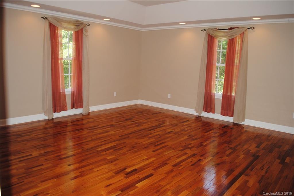 975 Jackson Road Salisbury, NC 28146 - Photo 14 of 24 a view of an empty room with wooden floor and a window