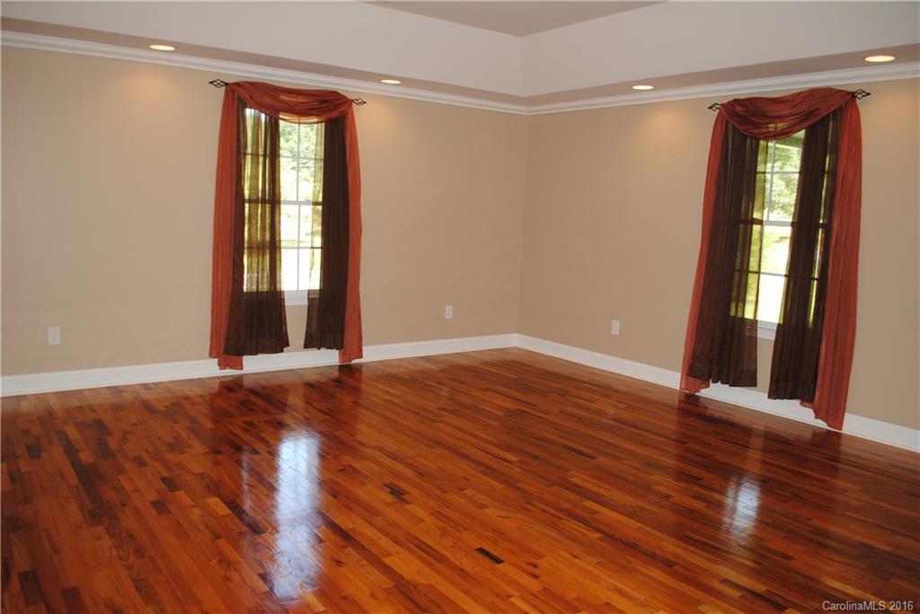 975 Jackson Road Salisbury, NC 28146 - Photo 15 of 24 a view of an empty room with wooden floor and a window