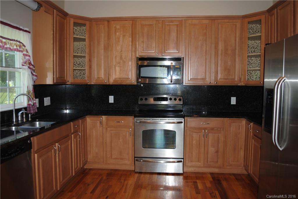 975 Jackson Road Salisbury, NC 28146 - Photo 5 of 24 a kitchen with stainless steel appliances a stove a microwave a sink and cabinets