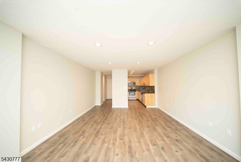 115 Polifly Road, Unit 5D Hackensack, NJ 07601 - Photo 4 of 10 a view of empty room with wooden floor