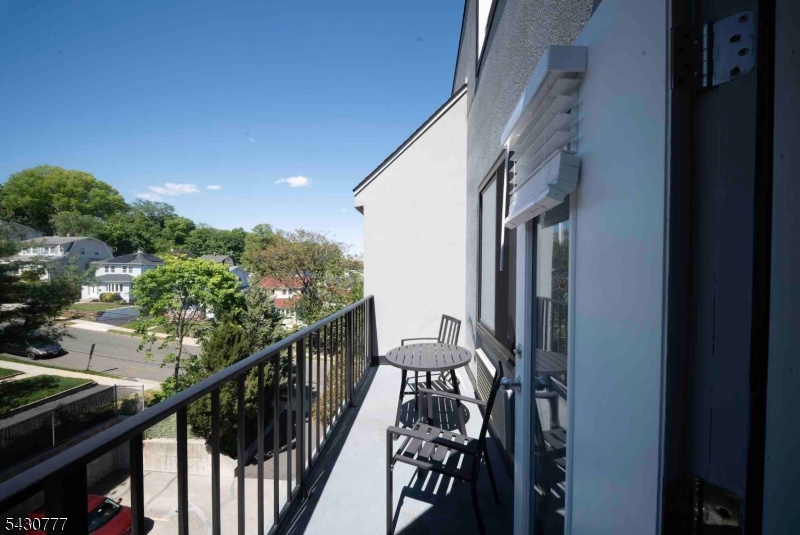 115 Polifly Road, Unit 5D Hackensack, NJ 07601 - Photo 7 of 10 a view of balcony with wooden floor and stairs