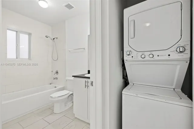 a bathroom with a toilet and a bathtub