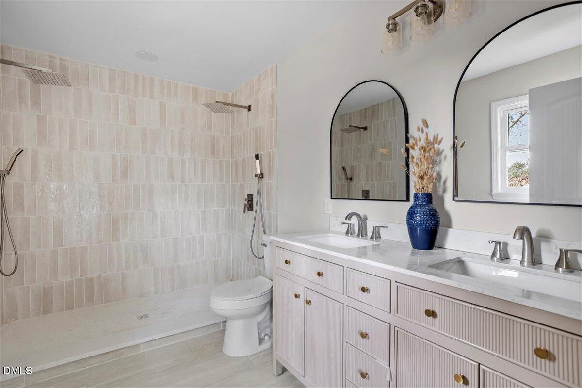 7589 Bray Road Bailey, NC 27807 - Photo 13 of 23 a bathroom with a double vanity sink toilet and shower