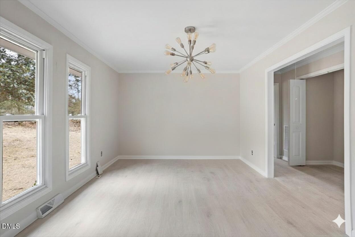 7589 Bray Road Bailey, NC 27807 - Photo 6 of 23 an empty room with windows and fan